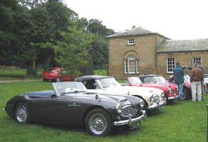 Members cars lined up outside the stable block.